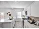Modern kitchen with white cabinets, quartz countertops, and stainless steel appliances at 1417 E Michigan St, Indianapolis, IN 46201