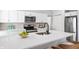 Modern kitchen featuring white cabinets, stainless steel appliances and a center island with barstool seating at 1417 E Michigan St, Indianapolis, IN 46201