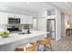 Modern kitchen featuring white cabinets, stainless steel appliances, and a breakfast bar for casual dining at 1417 E Michigan St, Indianapolis, IN 46201