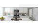 Modern kitchen with stainless steel appliances, white cabinets and a center island with a breakfast bar at 1417 E Michigan St, Indianapolis, IN 46201