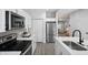 Bright kitchen featuring stainless steel appliances, white cabinets, and quartz countertops at 1417 E Michigan St, Indianapolis, IN 46201