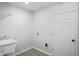 A laundry room offers a utility sink and door to the house at 1417 E Michigan St, Indianapolis, IN 46201