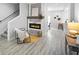 Bright living room featuring a fireplace, stairs, and sleek flooring for a modern touch at 1417 E Michigan St, Indianapolis, IN 46201