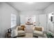 Bright office space with an open doorway showcasing a cozy living room and a glimpse of the bathroom at 1417 E Michigan St, Indianapolis, IN 46201