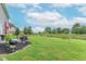 Expansive backyard featuring a seating area, well-maintained lawn, and beautiful landscaping at 1417 Layton Rd, Anderson, IN 46011