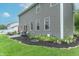 Spacious backyard with lush green grass, a patio area, and mature landscaping at 1417 Layton Rd, Anderson, IN 46011