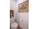 Powder room featuring a toilet with a decorative shelf, and a framed art piece on the wall at 1417 Layton Rd, Anderson, IN 46011