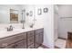 Bright bathroom with a double vanity, modern fixtures, and a shower with patterned curtain at 1417 Layton Rd, Anderson, IN 46011