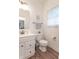 Bright bathroom with white vanity, toilet, and wood look flooring at 1417 Layton Rd, Anderson, IN 46011