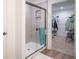 Modern bathroom featuring a tiled shower with glass door and a walk-in closet at 1417 Layton Rd, Anderson, IN 46011