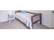Comfortable bedroom featuring a wooden bed frame, neutral carpet, and a white nightstand at 1417 Layton Rd, Anderson, IN 46011