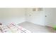 Bright bedroom with white walls and neutral carpet, featuring a colorful quilt on the bed at 1417 Layton Rd, Anderson, IN 46011