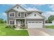 Charming two-story home with gray siding, white trim, and a well-manicured lawn at 1417 Layton Rd, Anderson, IN 46011