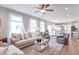 Spacious living room featuring a ceiling fan, plush seating, and an open floor plan leading to the kitchen at 1417 Layton Rd, Anderson, IN 46011