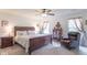 Cozy bedroom featuring a ceiling fan, a comfortable bed, and natural light from the window at 1417 Layton Rd, Anderson, IN 46011