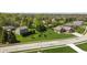 Aerial view of brick home with lush landscaping, mature trees and well maintained lawn and two car garage at 1426 Manchester Dr, Danville, IN 46122