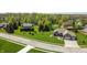 Aerial view of house with brick facade and beautiful landscaping and well maintained green lawn at 1426 Manchester Dr, Danville, IN 46122