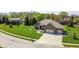 This aerial view shows a home with well manicured lawn, brick facade and a two-car garage at 1426 Manchester Dr, Danville, IN 46122