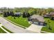 Aerial view of a brick home with manicured lawn and landscaping and a two-car attached garage at 1426 Manchester Dr, Danville, IN 46122