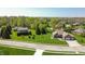 Aerial view of brick home with mature trees, well maintained lawn and two car attached garage at 1426 Manchester Dr, Danville, IN 46122