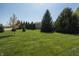 Well-manicured lawn and landscaping in the backyard enhances the beauty of this property at 1426 Manchester Dr, Danville, IN 46122