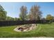 Picturesque backyard featuring a decorative rock garden with a calming water feature and lush green lawn at 1426 Manchester Dr, Danville, IN 46122