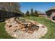 Serene backyard with a beautifully crafted rock waterfall and lush greenery, perfect for relaxation at 1426 Manchester Dr, Danville, IN 46122