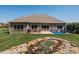 Spacious backyard showcasing a beautiful rock garden and a patio with outdoor seating at 1426 Manchester Dr, Danville, IN 46122
