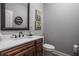 This half-bathroom features wood cabinets, modern faucet, white marble counter and decorative mirror at 1426 Manchester Dr, Danville, IN 46122