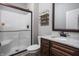 This modern bathroom features a glass shower door, granite counters, dark wood cabinets and shelving at 1426 Manchester Dr, Danville, IN 46122