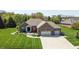 Beautiful brick home with an attached two-car garage and professionally landscaped front yard at 1426 Manchester Dr, Danville, IN 46122
