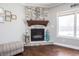 Close-up of a cozy fireplace with stone surround, wooden mantel, and decorative accents at 1426 Manchester Dr, Danville, IN 46122