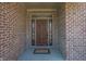 Elegant wooden front door with decorative glass sidelights and transom, set in a brick facade at 1426 Manchester Dr, Danville, IN 46122