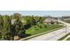 Beautifully landscaped front yard with mature trees, green lawn, and a brick home at 1426 Manchester Dr, Danville, IN 46122