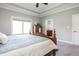 Bright main bedroom with ensuite bathroom featuring a wooden four-poster bed and neutral carpet at 1426 Manchester Dr, Danville, IN 46122