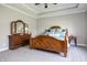 Elegantly designed main bedroom featuring a wooden four-poster bed, dresser, and neutral carpet at 1426 Manchester Dr, Danville, IN 46122