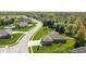 Aerial view showcases a peaceful neighborhood featuring manicured lawns and tree-lined streets at 1426 Manchester Dr, Danville, IN 46122