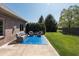 Inviting outdoor patio with comfortable furniture and a landscaped yard perfect for entertaining at 1426 Manchester Dr, Danville, IN 46122
