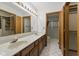 Double sink bathroom with walk-in closet and glass-enclosed shower at 15 Northridge Ct, Brownsburg, IN 46112