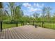 The new deck boasts brown deck boards with a railing overlooking the lush backyard, perfect for outdoor relaxation at 15 Northridge Ct, Brownsburg, IN 46112