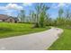 Long driveway leading to a beautiful home surrounded by mature trees and lush greenery on a large lot at 15 Northridge Ct, Brownsburg, IN 46112