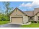 This home boasts a 2-car garage with a neutral door, stone accents, and manicured lawn at 15 Northridge Ct, Brownsburg, IN 46112