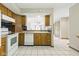 Traditional kitchen with tile floor, white appliances, and wooden cabinets and countertops at 15 Northridge Ct, Brownsburg, IN 46112