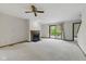 Spacious living room with a fireplace, ceiling fan, and access to the outdoor patio at 15 Northridge Ct, Brownsburg, IN 46112
