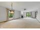 Bright living room with a fireplace, neutral carpet, and sliding doors to the patio at 15 Northridge Ct, Brownsburg, IN 46112