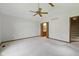 Large main bedroom with neutral carpet leading to an ensuite bath and stairs at 15 Northridge Ct, Brownsburg, IN 46112