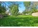 Spacious backyard featuring lush green grass and mature trees at 155 Suncrest Dr, Greenwood, IN 46143