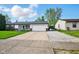 Well-maintained home with an attached garage and large driveway, perfect for multiple vehicles at 155 Suncrest Dr, Greenwood, IN 46143