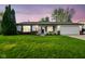 Charming single-story home featuring a well-manicured lawn, attached garage, and inviting front porch at 155 Suncrest Dr, Greenwood, IN 46143