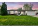 Charming single-story home featuring a well-manicured lawn, attached garage, and inviting front porch at 155 Suncrest Dr, Greenwood, IN 46143